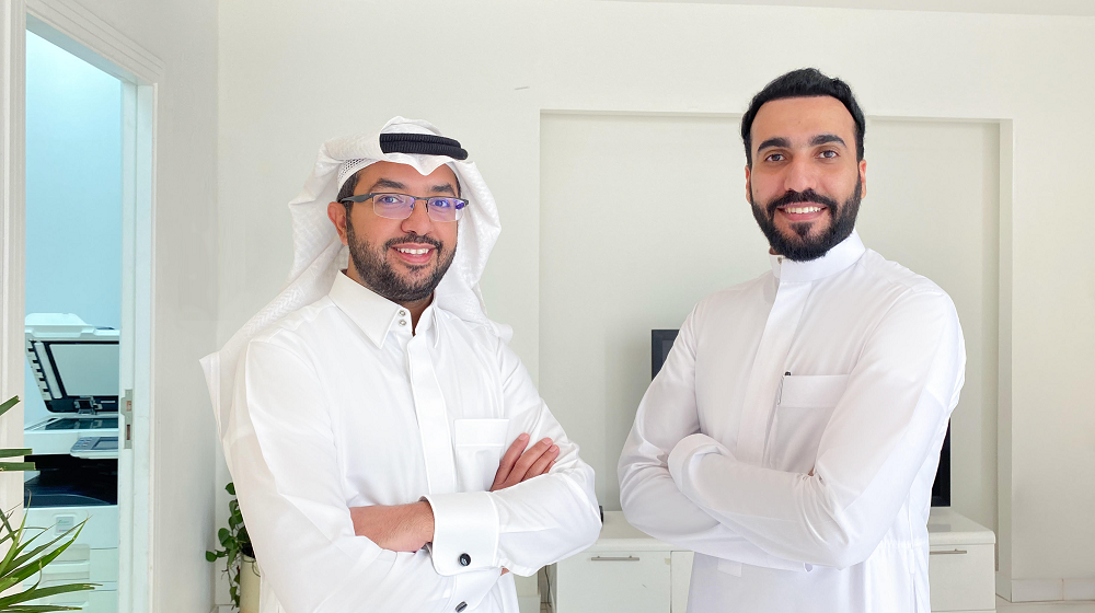 The two co-founders of Telgani, standing together in the company's office.